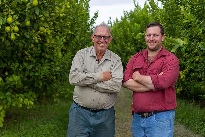 Oscar and Dwaine Bugno stand in their fruit orchard.