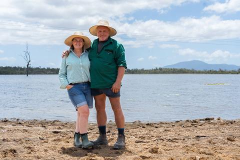 Sharron and William Pratt stand in front of their large dam