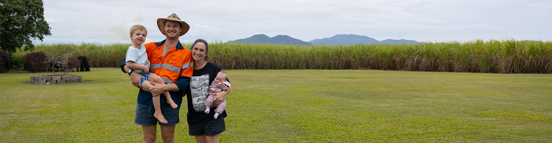 Dylan and Sarah Wedel with their children on their cane farm near Mackay.